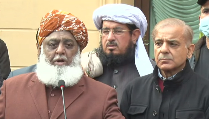 Pakistan Democratic Movement chief Maulana Fazlur Rehman (L) standing alongside Leader of the Opposition in the National Assembly Shahbaz Sharif in Islamabad on January 12, 2022 — Screengrab via Geo News.