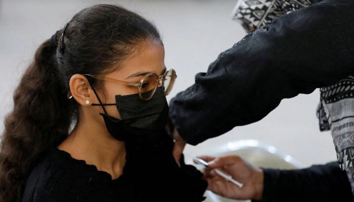 A girl receives a dose of the coronavirus disease (COVID-19) vaccine at a vaccination centre in Karachi, Pakistan December 15, 2021. — Reuters/File