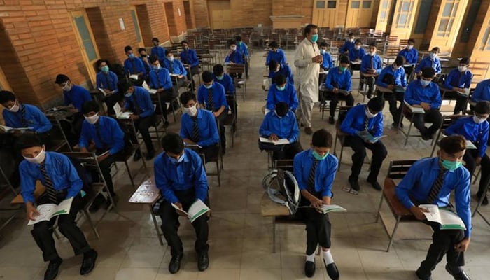 Students wear protective masks maintaining safe distance as they attend a class as schools reopen amid the coronavirus disease (COVID-19) pandemic, in Peshawar, Pakistan September 15, 2020. — Reuters/File