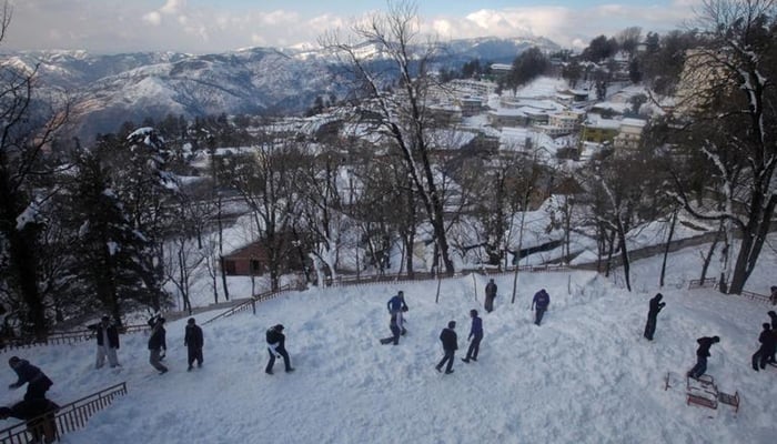 Tourists enjoy the snow at the hill resort town of Murree, 60 km (38 miles) northeast of the capital Islamabad, February 5, 2012. — Reuters/File