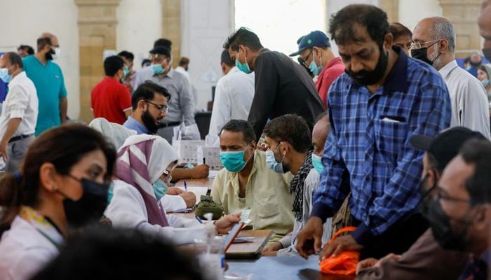 People gather to receive their coronavirus disease (COVID-19) vaccine doses, at a vaccination center in Karachi, Pakistan April 28, 2021. — Reuters/File