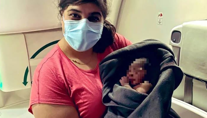 Aisha Khatib holding the miracle baby. — https://twitter.com/AishaKhatib