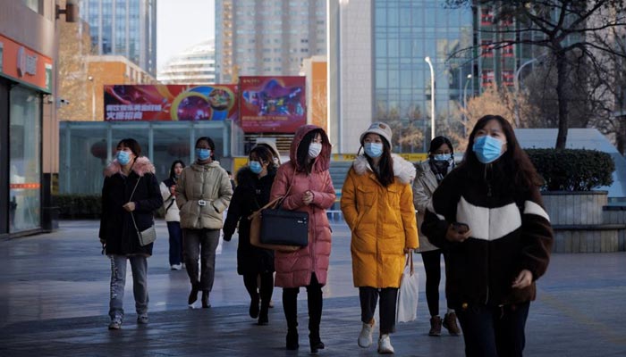 People walk on a street as the coronavirus disease (COVID-19) outbreak continues in Beijing, China, January 13, 2022. — Reuters/File