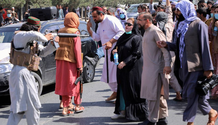 A member of the Taliban forces points his gun at protesters, as Afghan demonstrators shout slogans during a protest, in Kabul, Afghanistan September 7, 2021. — Reuters/Stringer/File photo