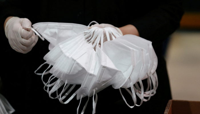 A worker sorts through N95 masks, made at the Strata Manufacturing facility, an Emirati factory producing parts for Airbus and Boeing jets, due to shortages of protective gear in some countries after the coronavirus disease (COVID-19) outbreak, in Al Ain, United Arab Emirates, July 8, 2020. — Reuters/Satish Kumar/File Photo