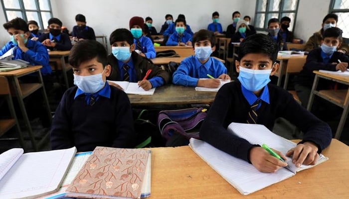 Students wear protective masks as they attend a class at school as the outbreak of coronavirus disease (COVID-19) continues, in Peshawar, Pakistan November 23, 2020. — Reuters/File