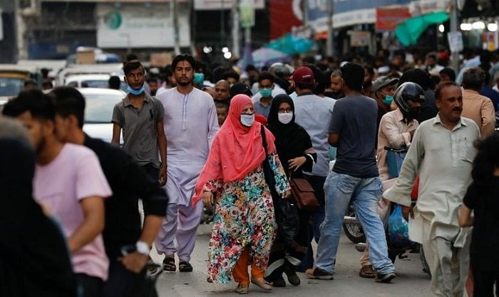 Women shop wearing mask shop in Karachi. — Reuters.