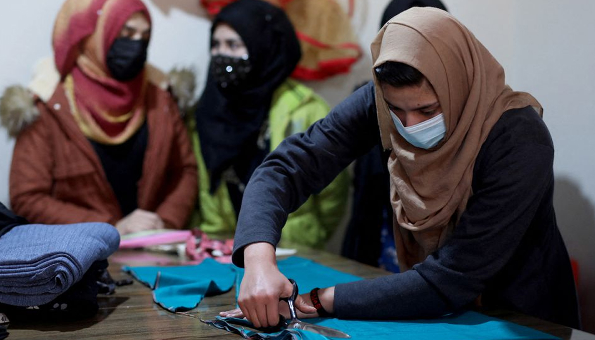 An Afghan woman cuts a fabric at a sewing workshop in Kabul, Afghanistan January 15, 2022. — Reuters
