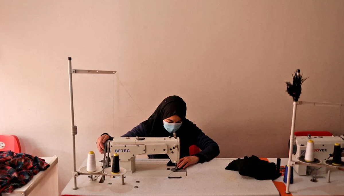 An Afghan woman uses a sewing machine to sew garments at a sewing workshop in Kabul, Afghanistan January 15, 2022. — Reuters