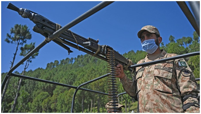 A Pakistani soldier patrols near the Line of Control, de facto border between India and Pakistan at Salohi village in Poonch district of Pakistan-administered Kashmir on April 26, 2021. (AFP)