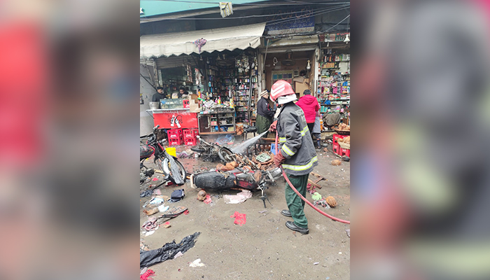 Rescue official extinguishes fire at site of the blast near Lohari Gate area in Lahore on January 20, 2021. — Twitter