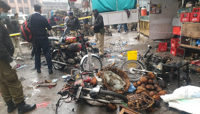 Police officials inspect the site of the blast near Lohari Gate area in Lahore on January 20, 2021. — Twitter