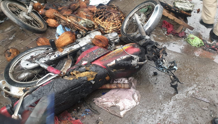 A burnt motorcycle can be at the site of the blast near Lohari Gate area in Lahore on January 20, 2021. — Twitter