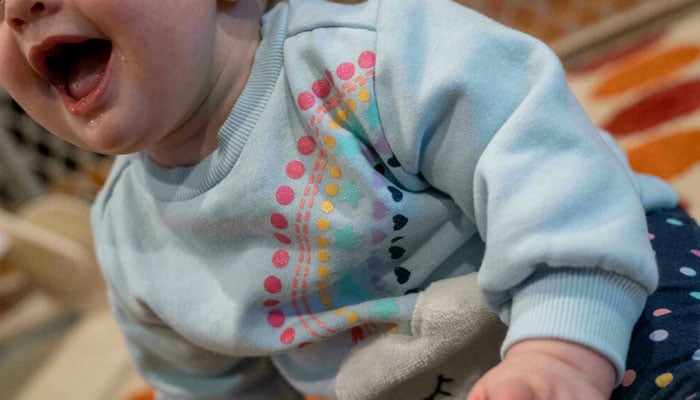 An 11-month-old baby plays with a teething toy on January 20, 2022 in Washington, DC. AFP