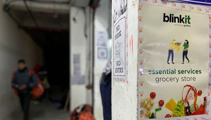 A delivery person leaves a dark store of the SoftBank-funded Blinkit, an Indian company which is offering 10 minute deliveries for groceries, in New Delhi, India, January 19, 2022. Picture taken on January 19, 2022. — Reuters