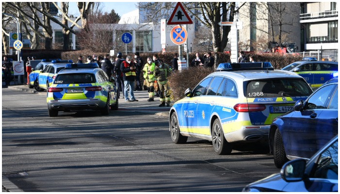 Police cars stand on the campus of the University in Heidelberg, southwestern Germany, after an attack on January 24, 2022. A gunman injured several people in a shooting inside a lecture hall at Heidelberg University, police said, adding that the perpetrator was now dead. — PRIEBE / DPA / AFP