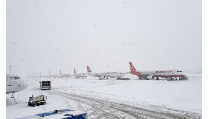 Turkish Airlines planes are stuck on the tarmac during snowfall on January 9, 2017 at Ataturk international airport in Istanbul. — AFP/File