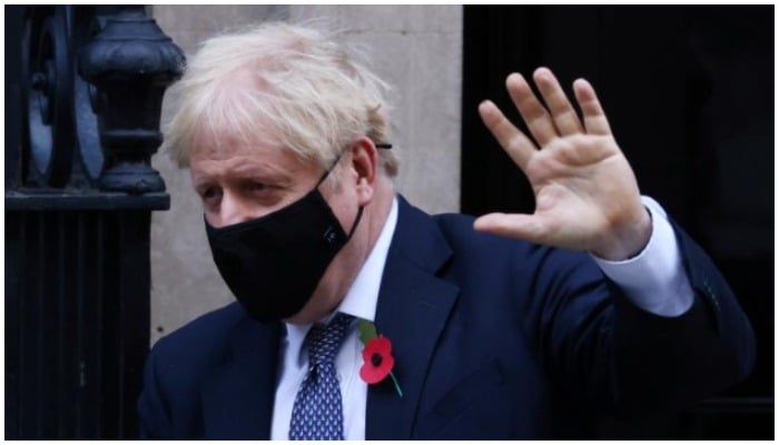 Britains Prime Minister Boris Johnson wearing a face mask as he leaves Downing Street, after new nationwide restrictions were announced during the coronavirus disease (COVID-19) outbreak in London, Britain, November 4, 2020. REUTERS/Simon Dawson