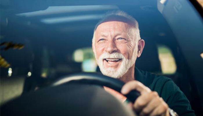 Representational image of a man driving a car while smiling — iStock/File