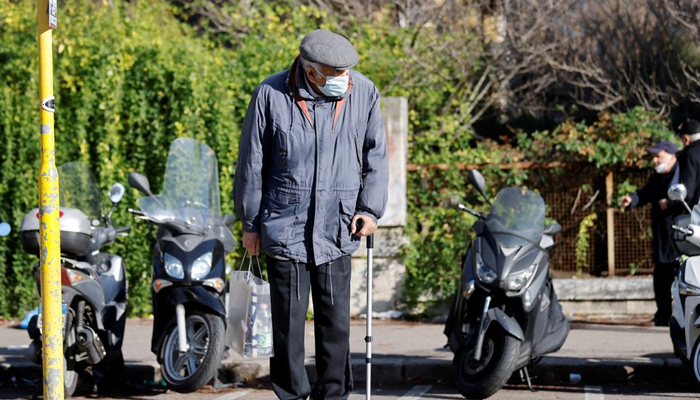 A man wearing a face mask waits for a tram, as the region of Lazio makes face masks mandatory outdoors in all areas, as coronavirus disease (COVID-19) cases rise and Christmas nears, in Rome, Italy, December 23, 2021. — Reuters