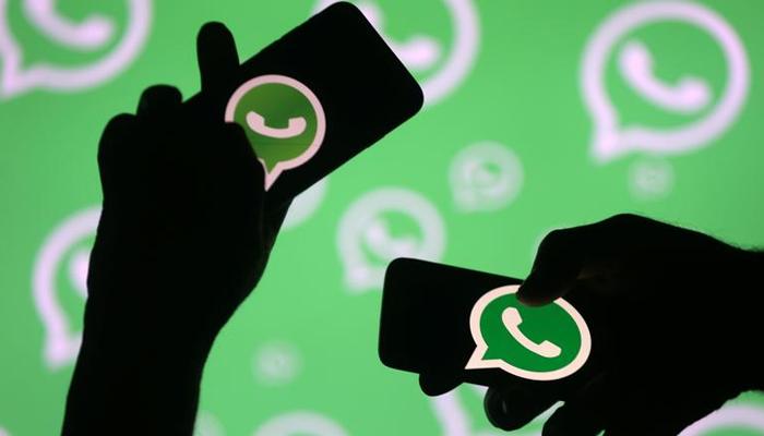Men pose with smartphones in front of displayed Whatsapp logo in this illustration September 14, 2017. — Reuters/File
