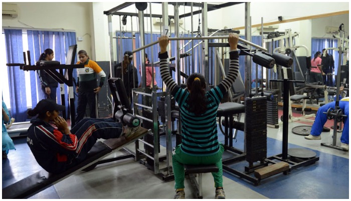 Female kabaddi athletes working out in a gym — AFP