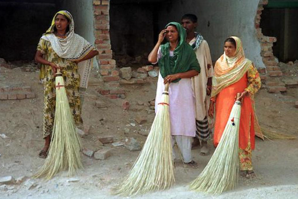Picture showing some domestic workers holding brooms — AFP