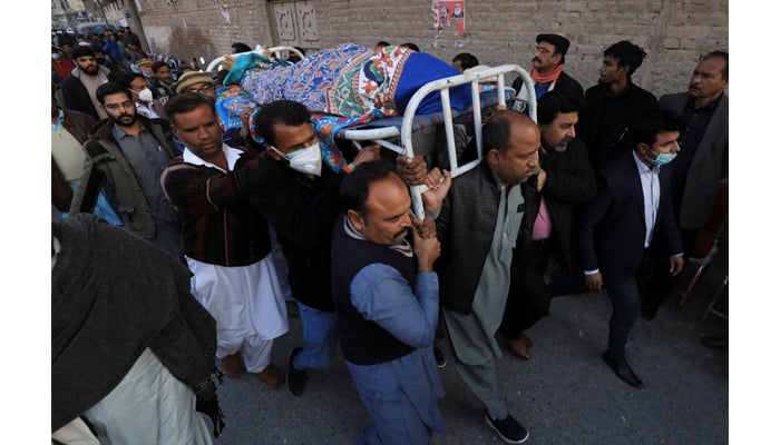 Men carry the body of priest William Siraj, who, according to police, was killed by unknown armed men in Peshawar, Pakistan January 30, 2022. — Reuters/File