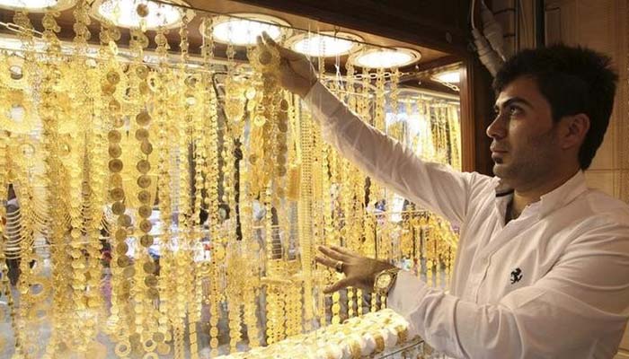 A goldsmith shop owner displays gold pieces at a gold market in Arbil, in Iraqs Kurdistan region, March 16, 2014. — Reuters/File