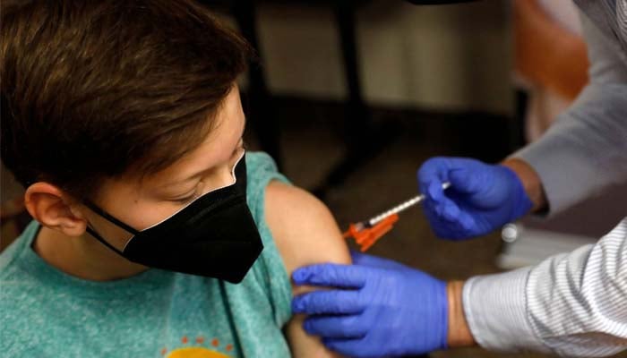 A boy receives the Pfizer-BioNTech COVID-19 vaccine in Bloomfield Hills, Michigan, in May. –AFP-JIJI