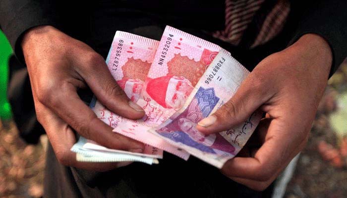 Rs50 and Rs100 Pakistani currency notes can be seen in this file image,&mdash; Reuters