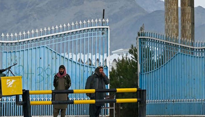 Taliban fighters stand guard at the main gate of Laghman University after classes resumed for the first time since the hardline Islamist group returned to power — Mohd RASFAN AFP