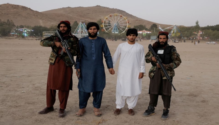Taliban members posing for the camera within the vicinity of an amusement park — REUTERS/Jorge Silva
