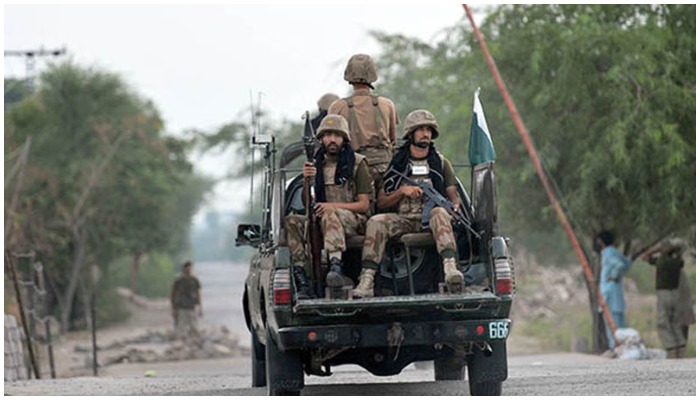 Armed security forces personnel ride on an army van. Photo: AFP