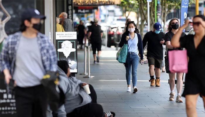 Shoppers walk through a retail district in the wake of coronavirus disease (COVID-19) lockdown restrictions being eased in Auckland, New Zealand, November 10, 2021. — Reuters/File