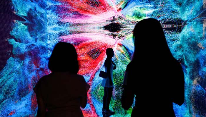Visitors are pictured in front of an immersive art installation titled Machine Hallucinations - Space: Metaverse by media artist Refik Anadol, which will be converted into NFT and auctioned online at Sothebys, at the Digital Art Fair, in Hong Kong, China September 30, 2021. — Reuters/File