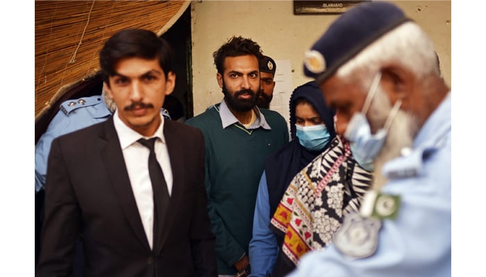 Policemen escort Zahir Jaffer (C) after his court hearing in Islamabad on October 20, 2021. — AFP/File