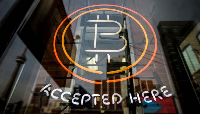 A Bitcoin sign is seen in a window in Toronto, May 8, 2014.— Reuters/File