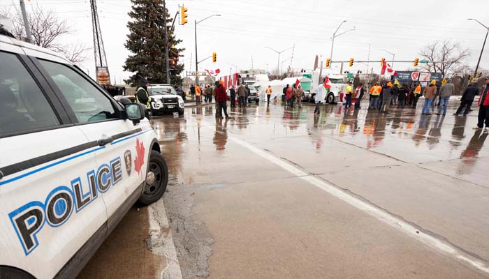 COVID-19 mandate protesters block the roadway at the Ambassador Bridge border crossing, in Windsor, Ontario, on February 11, 2022. (Photo by Geoff Robins / AFP)