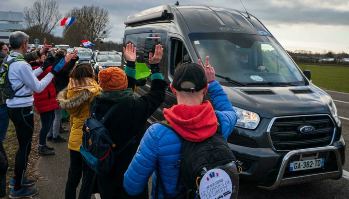 Supporters of the so-called Freedom Convoy cheer participants leaving Strasbourg. AFP