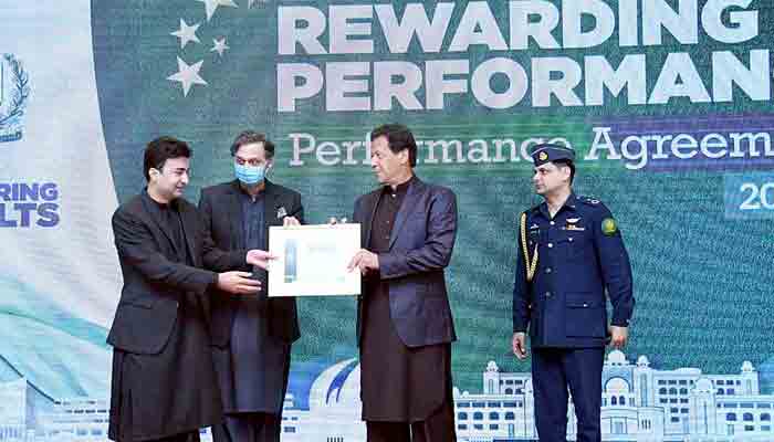 Prime Minister Imran Khan awards Performance Certificate to Minister for Communications Murad Saeed. -APP