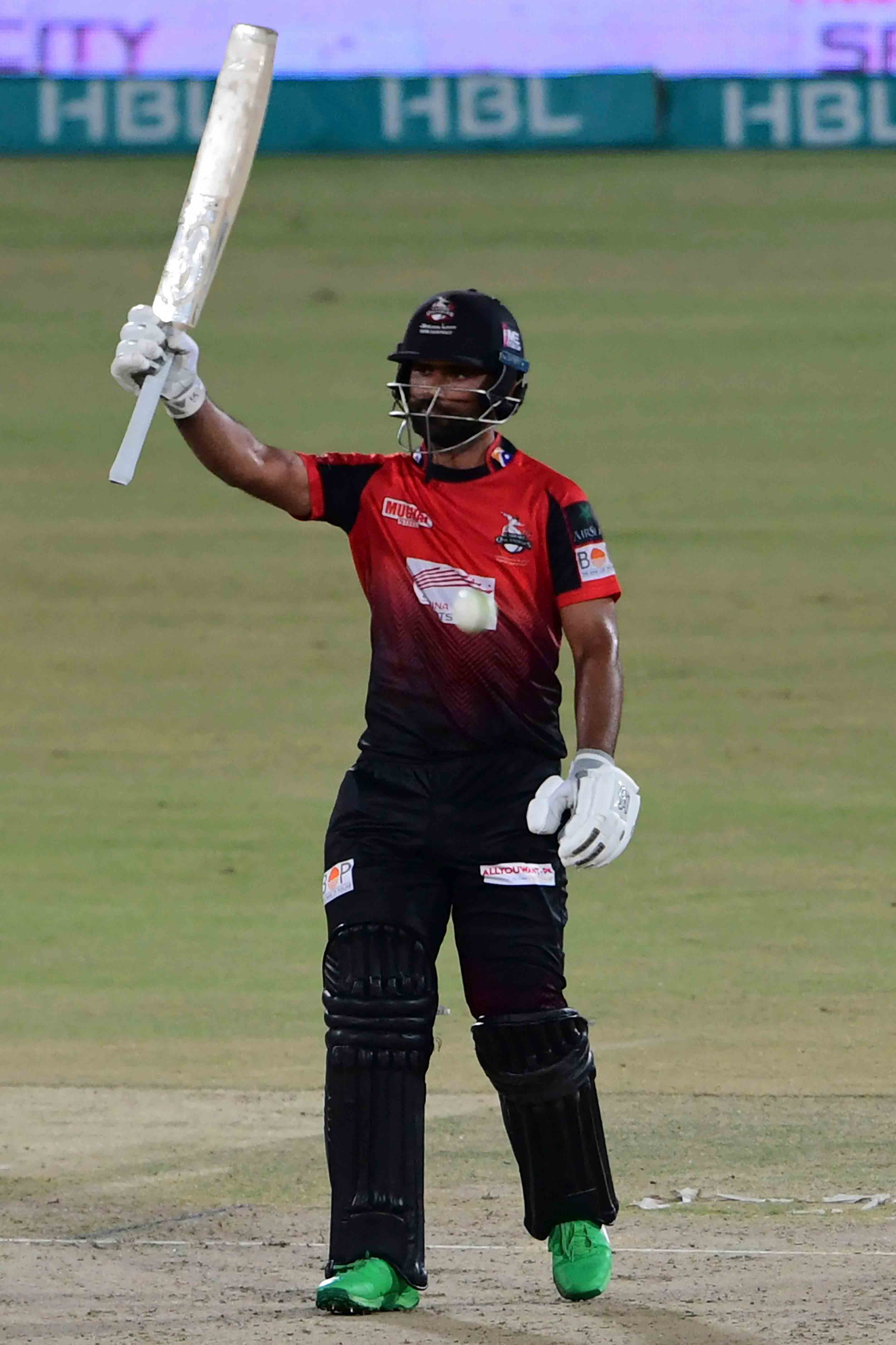 Lahore Qalandars´ Fakhar Zaman celebrates after scoring half century (50 runs) during the Pakistan Super League (PSL) Twenty20 cricket match between Quetta Gladiators and Lahore Qalandars at the National Cricket Stadium in Karachi on February 7, 2022. -AFP