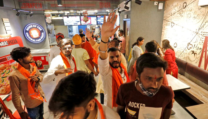 Activists of Bajrang Dal, a Hindu hardline group, shout slogans inside a Pizza Hut food outlet during a protest over their Pakistani partners tweet in support of Kashmir, in Ahmedabad, India, February 12, 2022. — Reuters