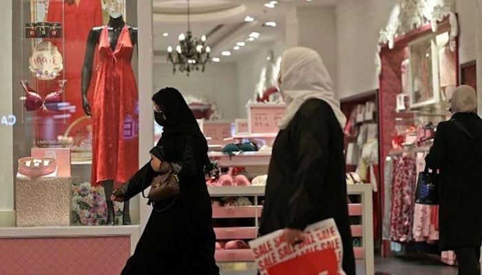 Some Saudi women are shopping as the shopfronts display red clothing and undergarments.Agencies