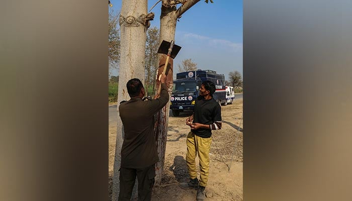 Police inspects the site where a man was killed after allegedly an angry mob stoned him to death at Khanewal district on February 13, 2022, — AFP