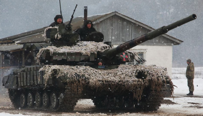 Service members of the Ukrainian Armed Forces drive a tank during military exercises in Kharkiv region, Ukraine February 10, 2022. &mdash; Reuters