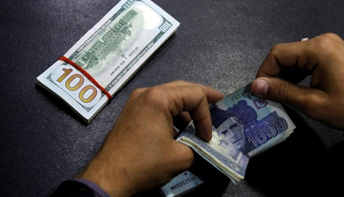 Image showing a person counting a stack of thousand-rupee notes — Reuters/File