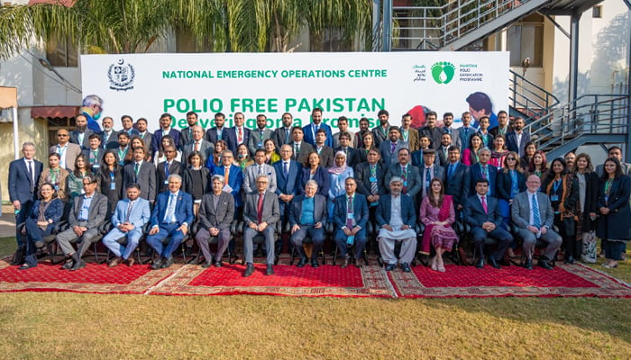 Microsoft co-founder and philanthropist Bill Gates poses for a group photo along with officials at the National Emergency Operations Centre (NEOC) in Islamabad, on February 17, 2022. — NEOC