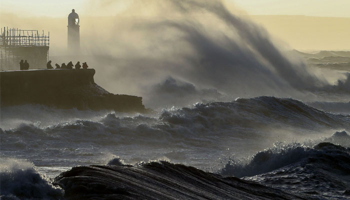 Waves crash against the sea wall at Porthcawl, south Wales, on February 18, 2022 as Storm Eunice brings high winds across the country. Photo— Geoff Caddick / AFP
