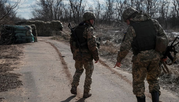 Ukrainian service members walk near the front line near the city of Novoluhanske in the Donetsk region, Ukraine February 20, 2022. — Reuters